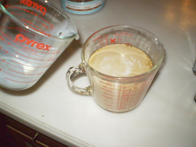 Mixing cream with the coffee
